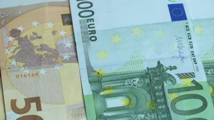欧元纸币的手动计数。现金100欧元票据。占五十欧元纸币。欧元现金背景。欧洲纸币是一种切向政策。外币的