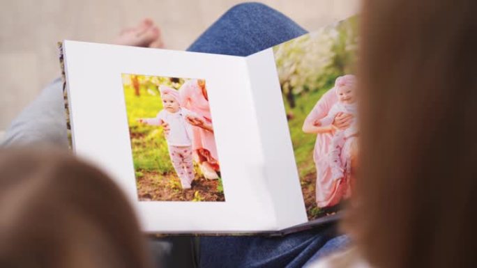 热门视图。她和女儿在春天的花园里看写真集家庭照片拍摄