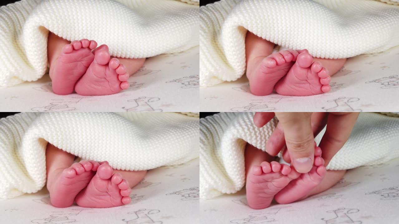 近距离拍摄的新生婴儿躺在尿布和抽搐她的小腿