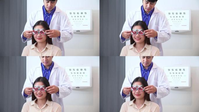 验光师男子测试视力测试用视力表，Snellen图和可调瞳孔间距离试验框架，用于亚洲年轻女性的视力，具