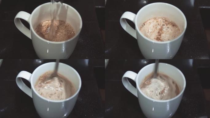 用速溶咖啡粉将热水倒入杯子中，然后用茶匙搅拌。