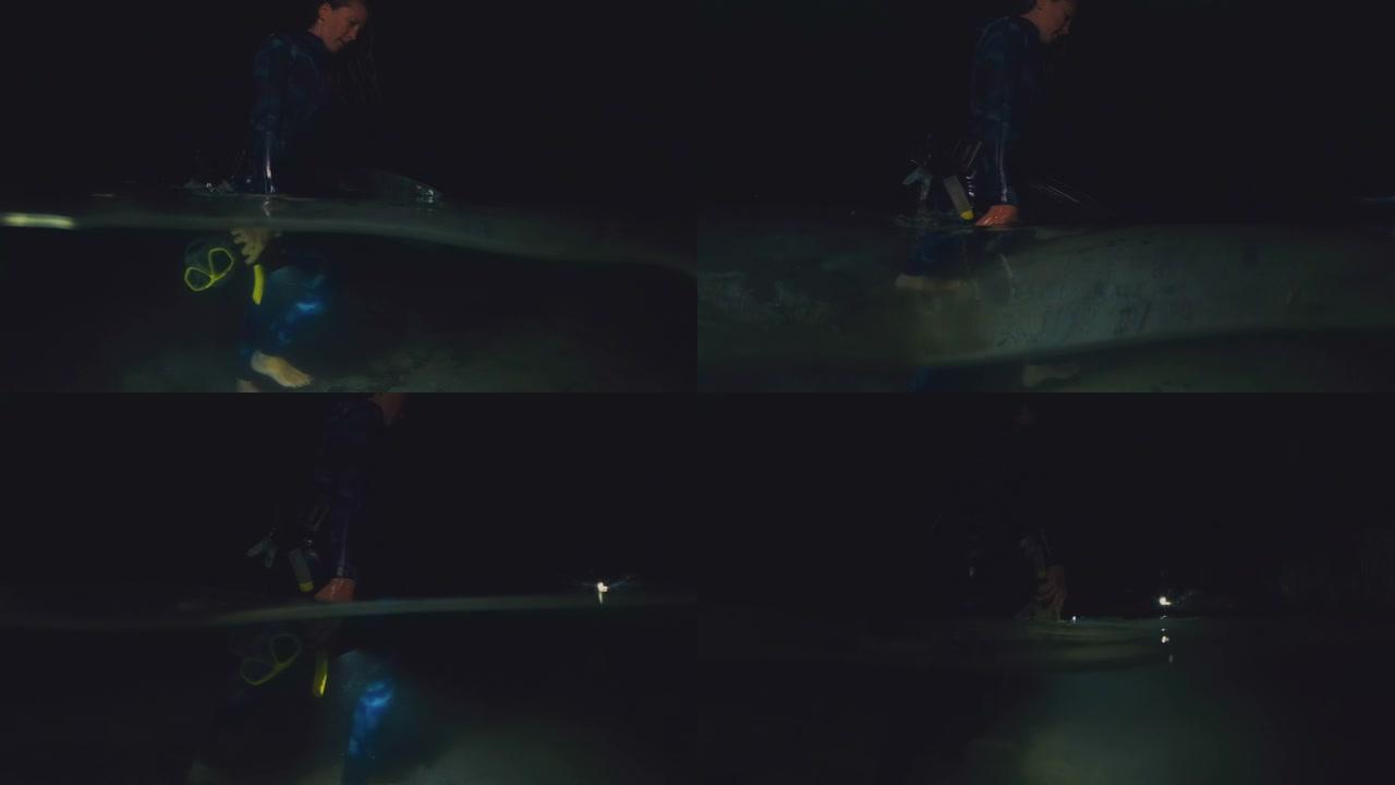 夜间自由潜水。穿着潜水衣的女人拿着面具浮潜，晚上从湖边散步。上方和下方的分割视图