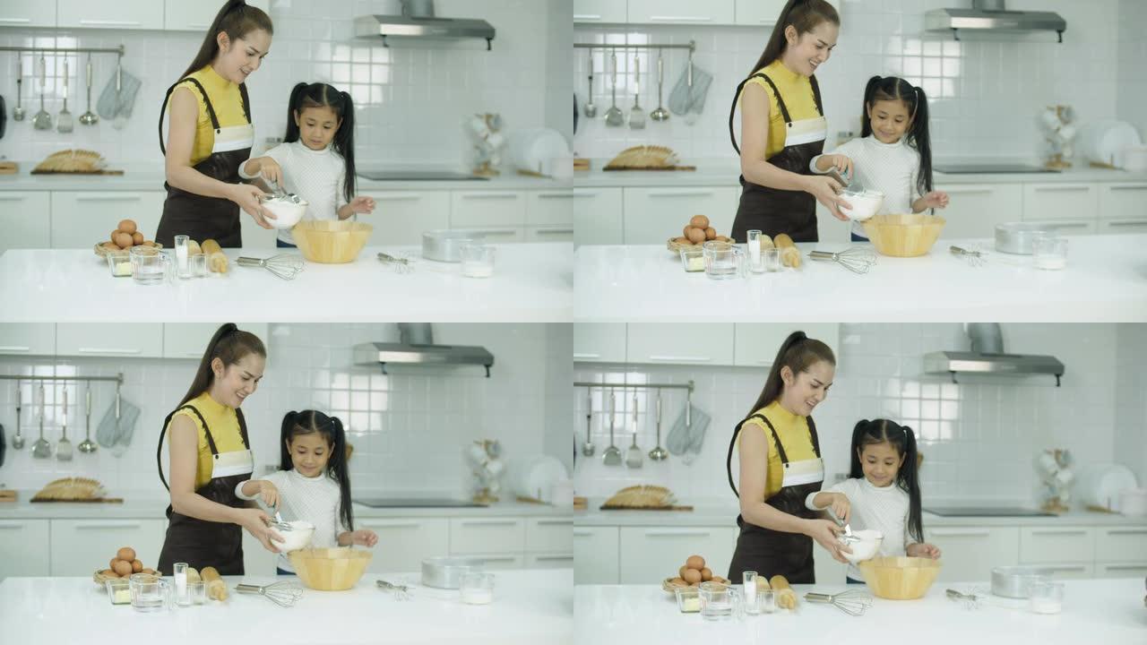 母亲和女儿在厨房里一起烘烤