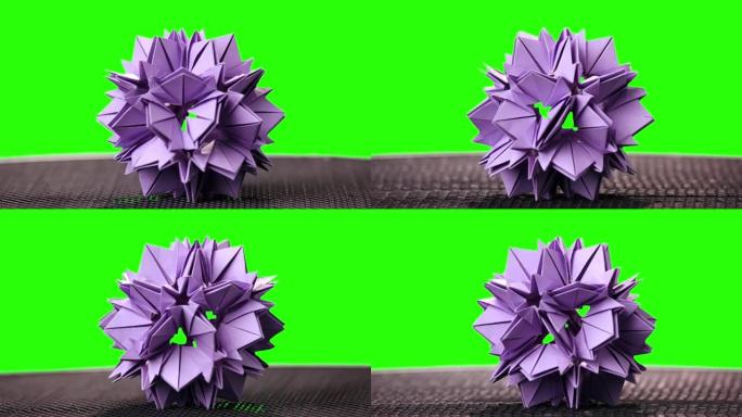 绿色屏幕上的紫罗兰折纸花。