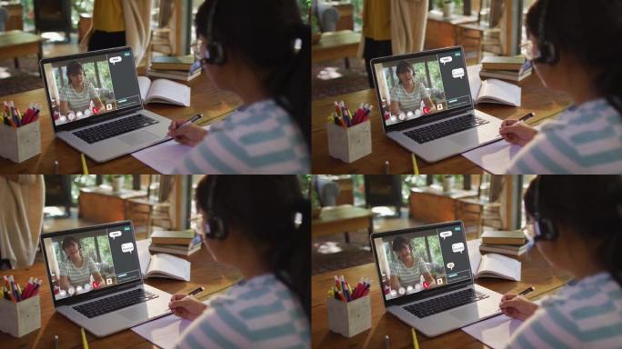 女孩在家做作业并与女老师在笔记本电脑上进行视频通话