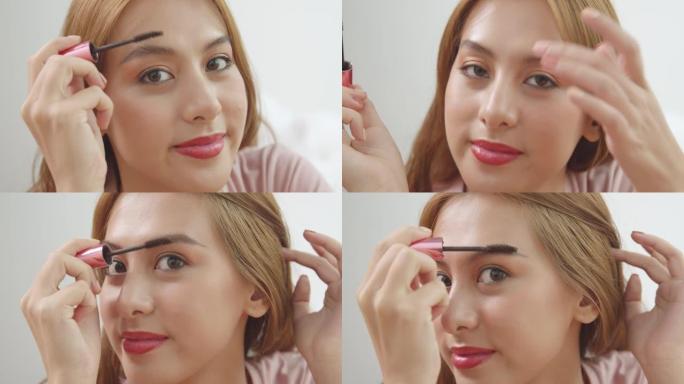 一个年轻的亚洲女人做化妆眉刷和照镜子的特写镜头。