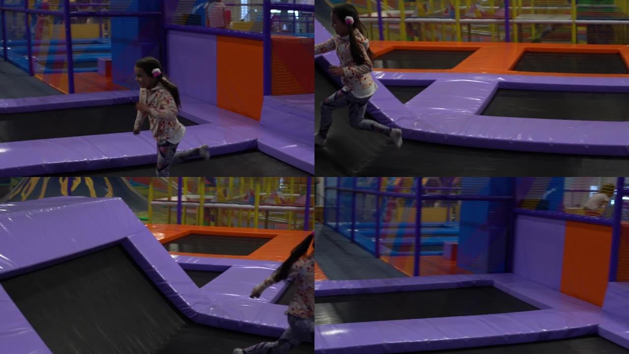 小女孩在蹦床游乐园游乐场嬉戏跳跃和滚动