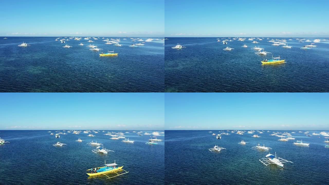 夏天，渔民和游客的船小心翼翼地停泊在菲律宾薄荷岛，薄荷岛，薄荷岛旁的塔比拉兰。