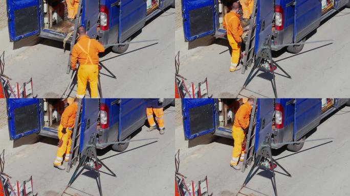 在新型冠状病毒肺炎大流行期间，戴着口罩的工人用切管机切割位于支架上的镀锌钢管，以修复地下天然气管线。