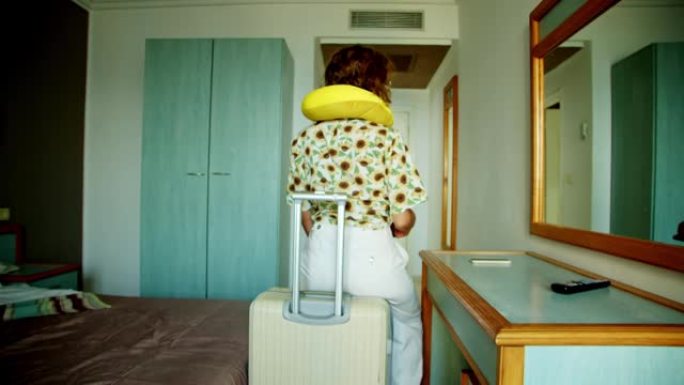 一位生气的游客坐在旅馆房间里的手提箱里，带着颈枕背对着相机。心烦意乱。女人把护照扔在桌子上。在国外自