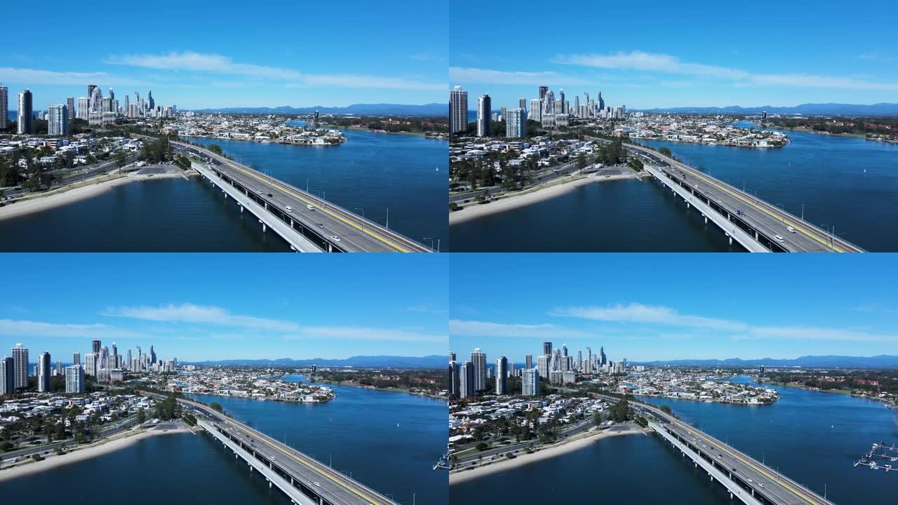 繁忙的城市道路网络和横跨大片水域的桥梁，通向大都市蔓延和高耸的天际线。