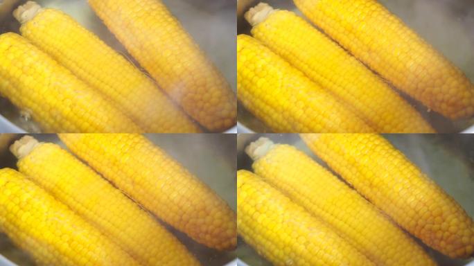 用热水煮玉米。在沸水中放入新鲜玉米的黄色玉米棒。视频4k分辨率