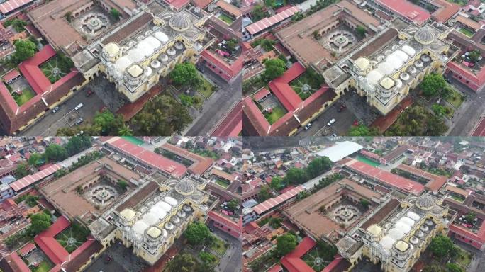 危地马拉安提瓜的空中无人机视图。飞越被联合国教科文组织保护的圣地亚哥大教堂和安提瓜主广场中央公园。
