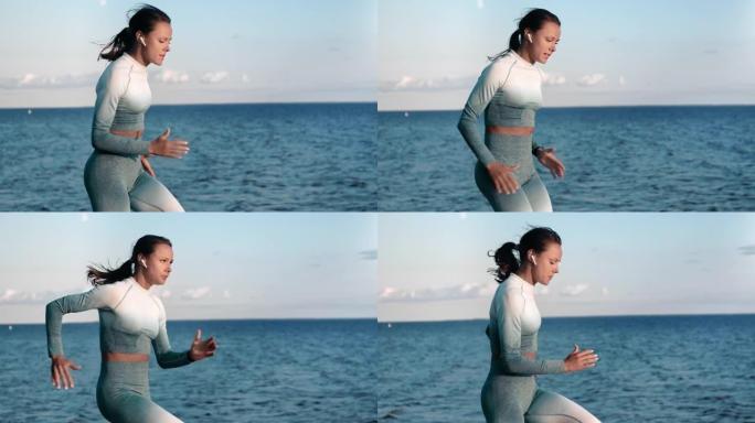 运动女子慢跑在自然海滩海边风景听音乐耳机