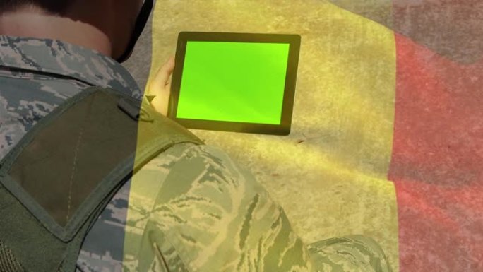 数字合成挥舞比利时国旗反对士兵使用数字平板与复制空间