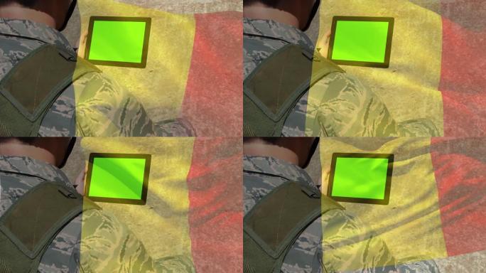 数字合成挥舞比利时国旗反对士兵使用数字平板与复制空间