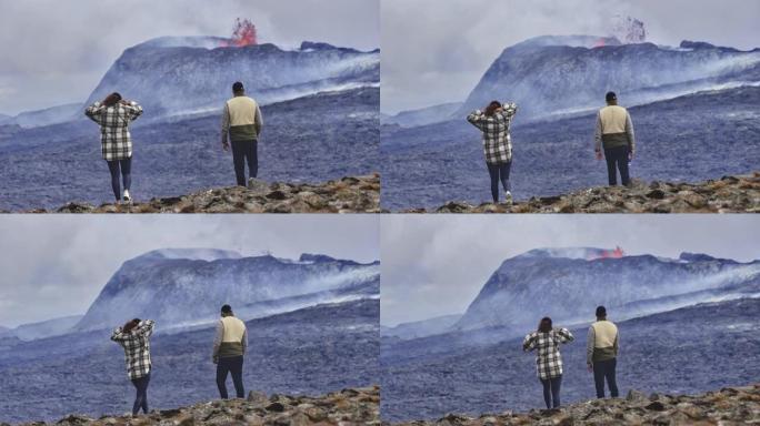 两名旅行者在岩石地上，可以看到火山爆发