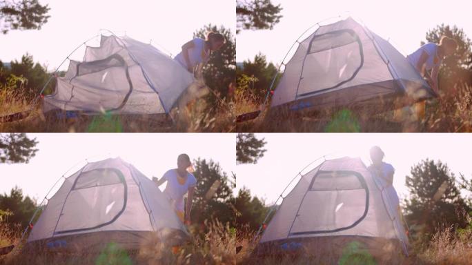 日落时搭帐篷，在大自然中露营。