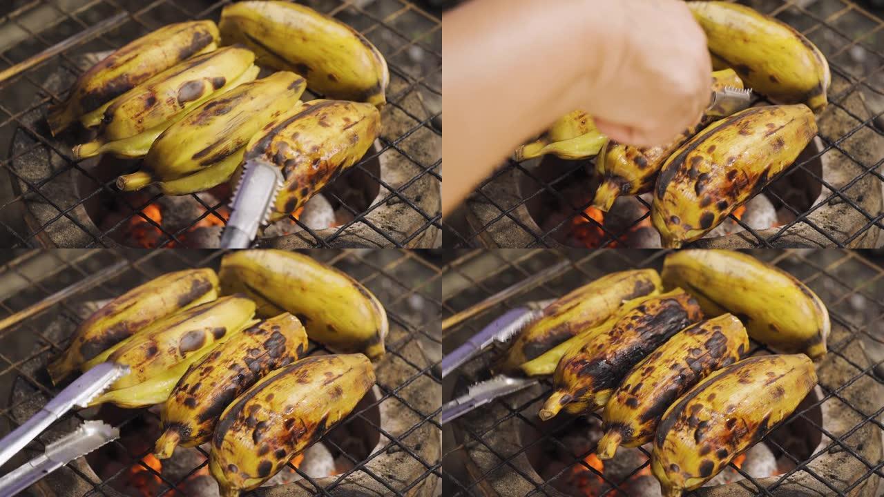 有人在传统的炭炉上翻转烤去皮的香蕉。烧烤食物。泰国菜。热带地区的甜果甜点。