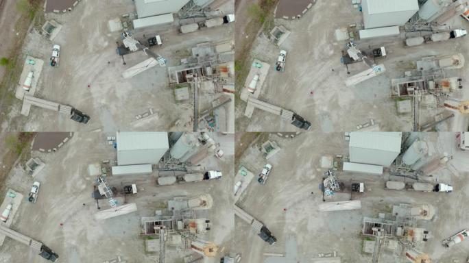 起重机的空中无人机视图在工厂卸下了承运人的卡车。顶视图