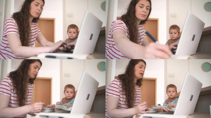 母亲在笔记本电脑上工作，并试图在家庭办公室喂养顽皮的男婴