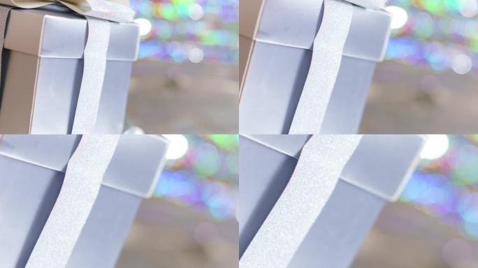 一个漂亮的礼品盒，银色蝴蝶结在闪闪发光的银色背景上。