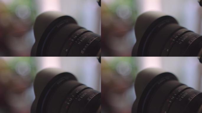 在摄影过程中，用手转动镜头上的光圈环，特写镜头。