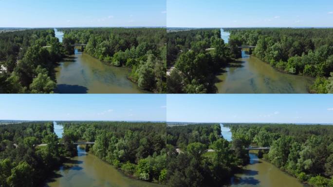 森林沿岸和公路桥梁的河流，鸟瞰图
