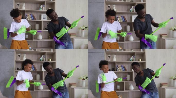 美国黑人混血儿子和爸爸打扫房子，假装在弹吉他Spbi。有趣