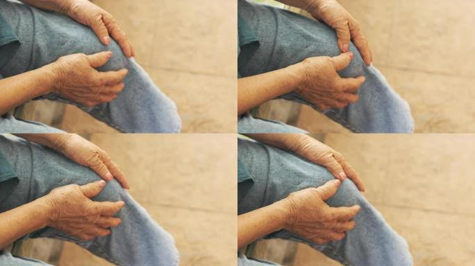 近距离4k坐着的老年人膝盖，手触摸或抓着，因为感觉疼痛和受伤，显示老年人由于肌肉无力和关节疼痛而导致