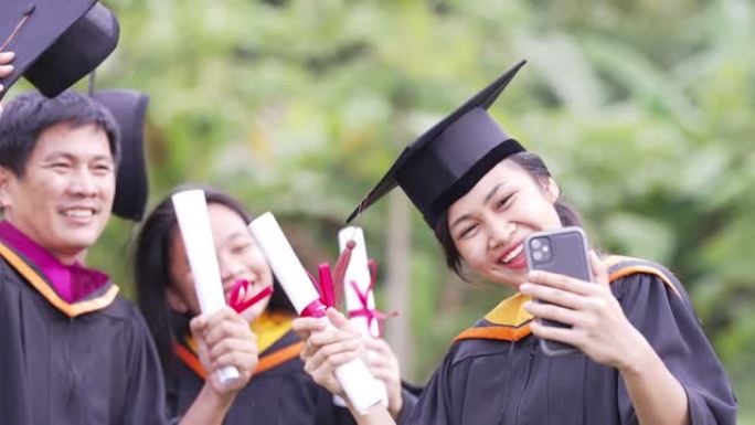 毕业生正在庆祝毕业典礼举手颁发证书，并盖帽庆祝毕业日。