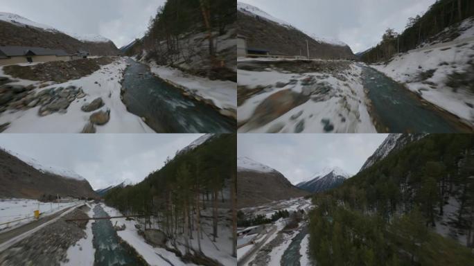 空中电影视角fpv运动无人机飞越自然岩石雪峰风景和狭窄河流