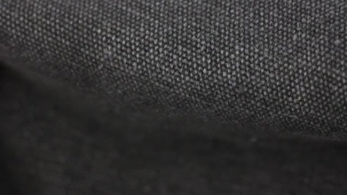 黑色防水布织物纺织材料的运动，宏观特写视图