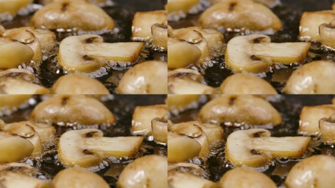 切成薄片的香菇在热锅中近距离油炸。金片香菇在橄榄油中油炸。美丽的餐厅烹饪壁纸。慢动作