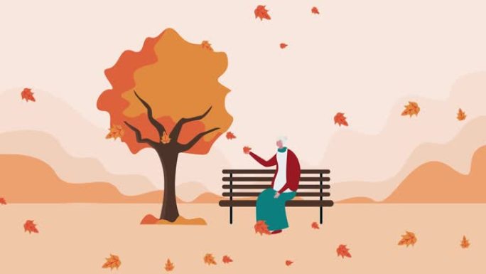 老妇人在公园里拿着落叶