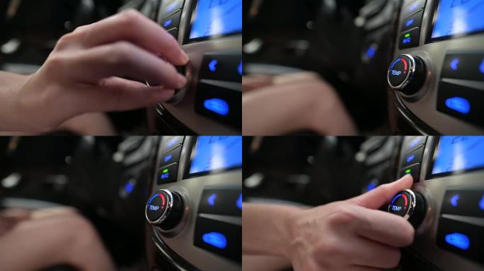 女人旋转汽车空调系统的温度控制旋钮