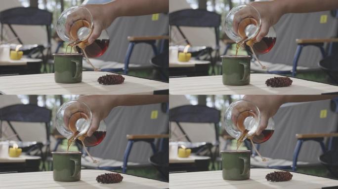 年轻人在桌子上煮咖啡。户外露营的滴咖啡过程