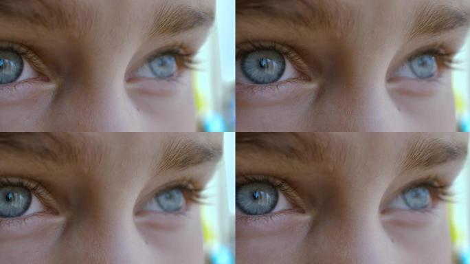 蓝眼睛的孩子看介绍距离特写。微距镜头打开和关闭蓝眼睛小女孩。儿童眼睛的特写动作。人眼虹膜开放瞳孔。
