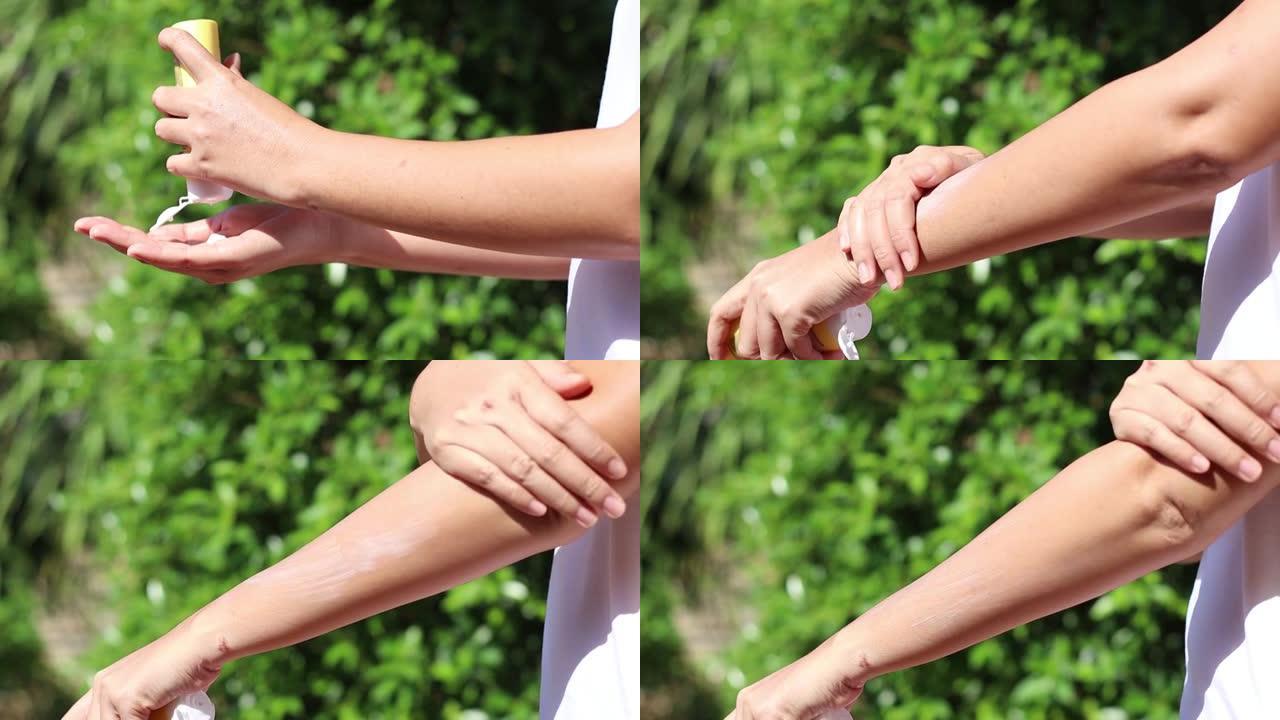 一名女子将防晒霜挤在手掌上，并将其涂抹在手臂上，以防止紫外线照射