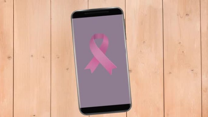 智能手机屏幕上粉色乳腺癌丝带标志的动画