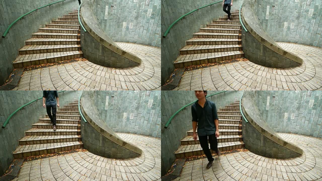 男子走下楼梯，在新加坡坎宁堡公园的隧道中，石头走道地下穿越