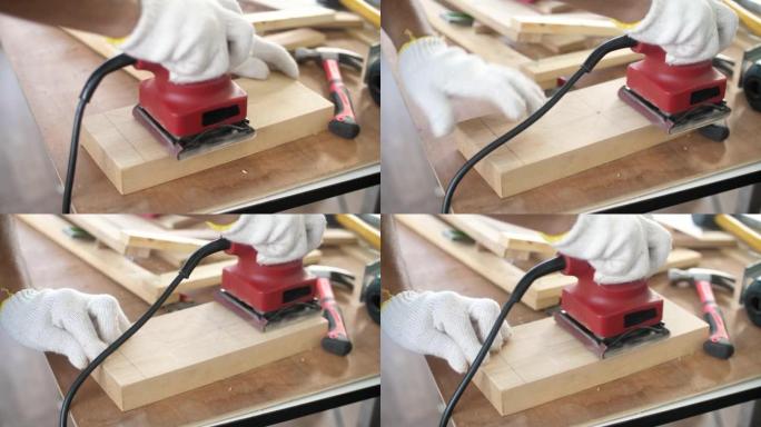 木匠在车间用砂光机打磨木材，木匠在表面上用电动砂光机打磨木材