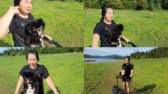 年轻女子夏天在湖和山上旅行机智狗