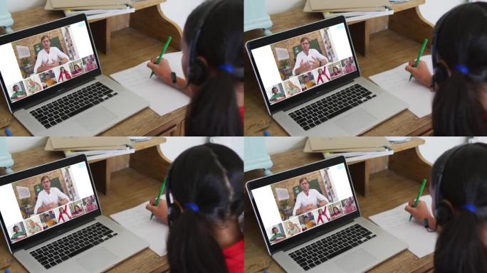 女孩在家做作业并与老师和同学在笔记本电脑上进行视频会议