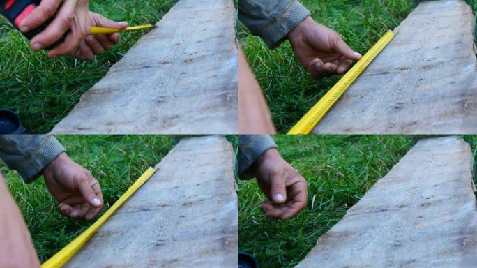 男性建筑商用卷尺或标尺测量木板