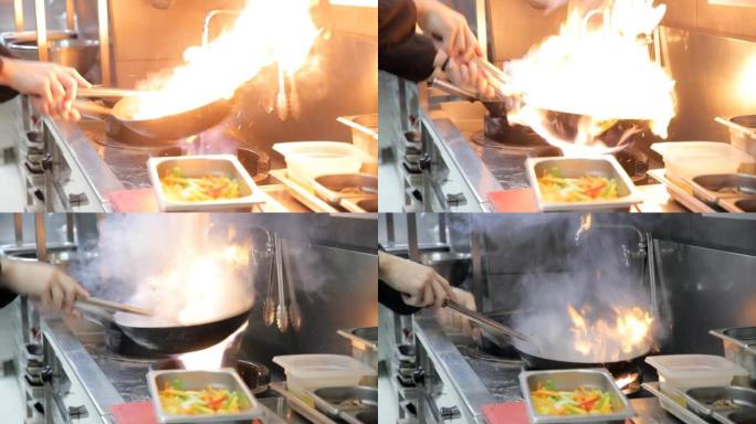 厨师的手将水包倒在热油中的锅中，在燃气灶火焰上