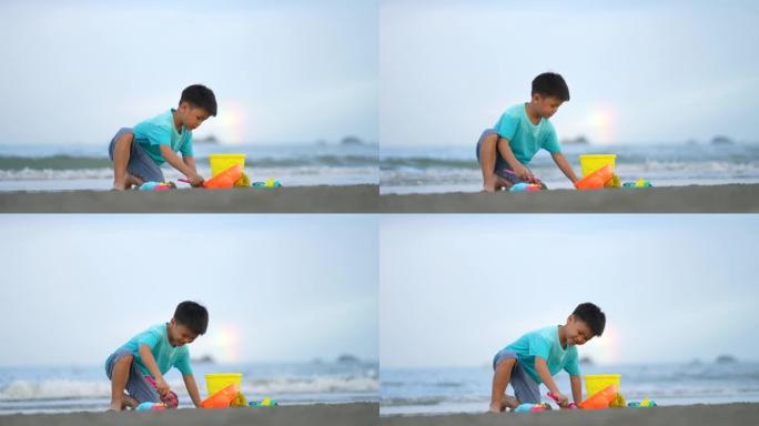 亚洲孩子在海滩玩沙堡