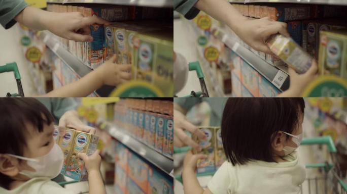 亚洲孕妇在超市推着购物车。