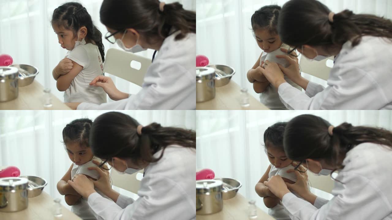 女医生在接种后用绷带包扎手臂，儿童，注射，新型冠状病毒肺炎接种