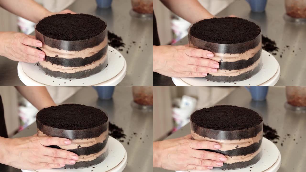 4k女糕点厨师在醋酸纤维薄膜中制作巧克力蛋糕，特写。慢动作。蛋糕制作过程。